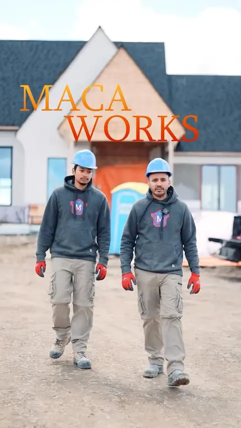 Moises and a Macaworks mason walking a custom home build site
