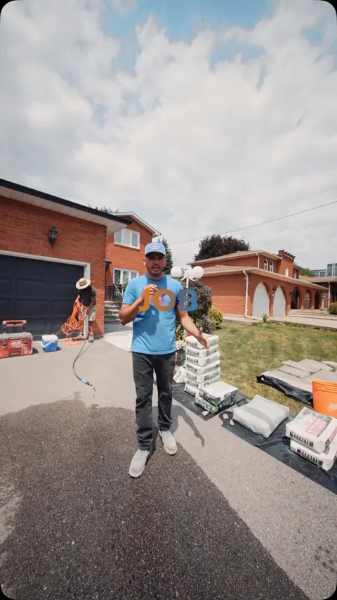 Moises on a driveway job with pallets of stone ready to lay