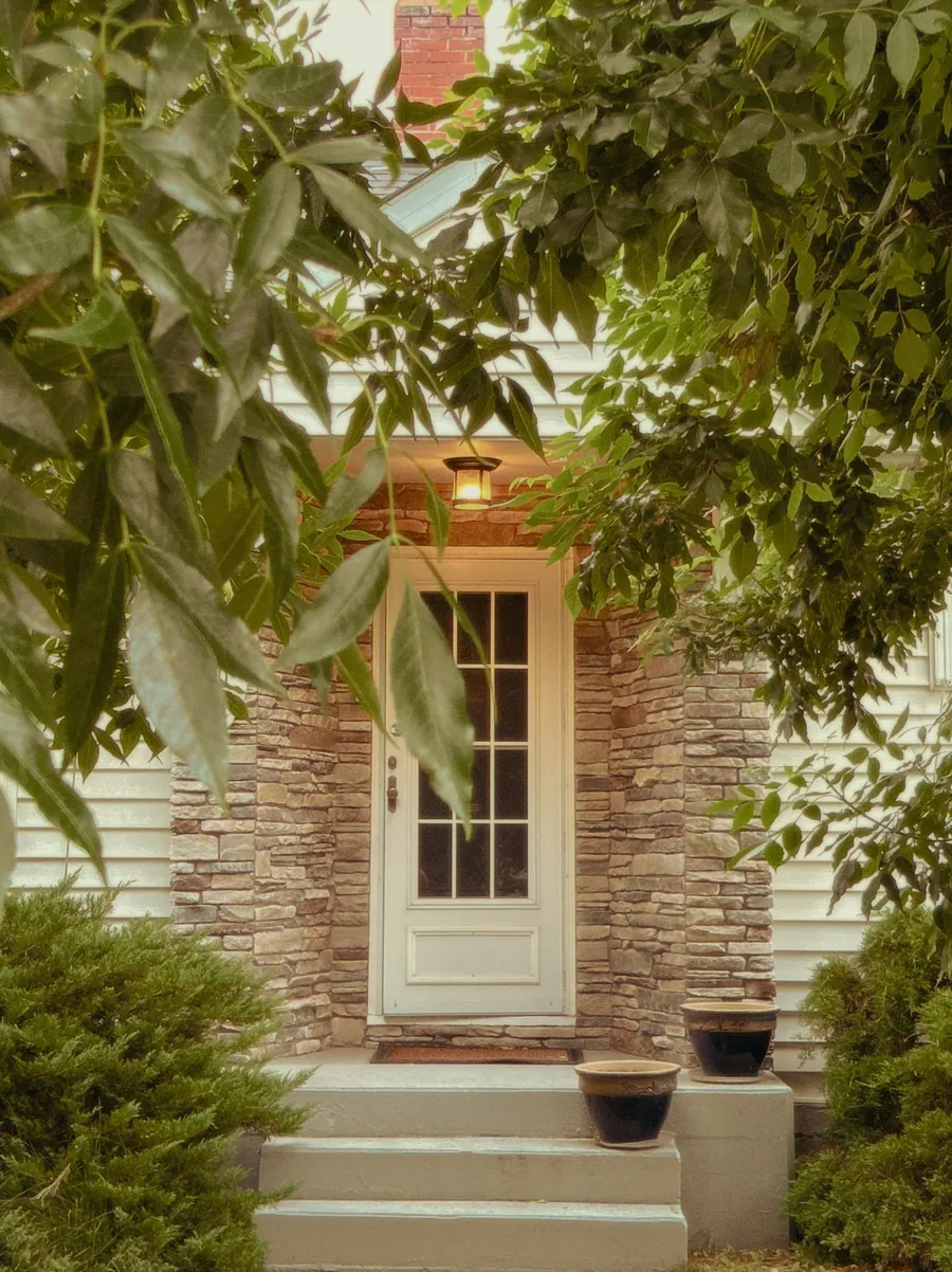Front entrance with a stone faced porch and stone steps